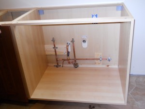 The new sink cabinet in place and the under-sink supply plumbing done!